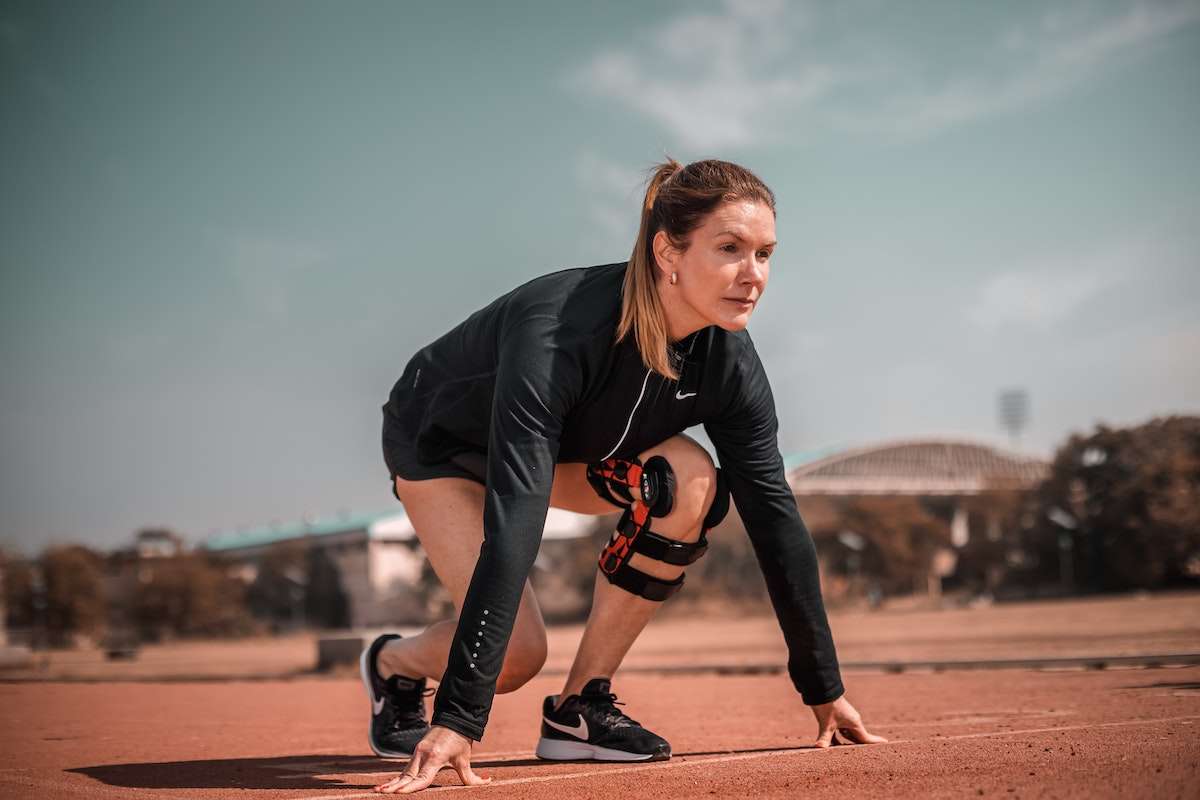 Motivational image of woman preparing to run
