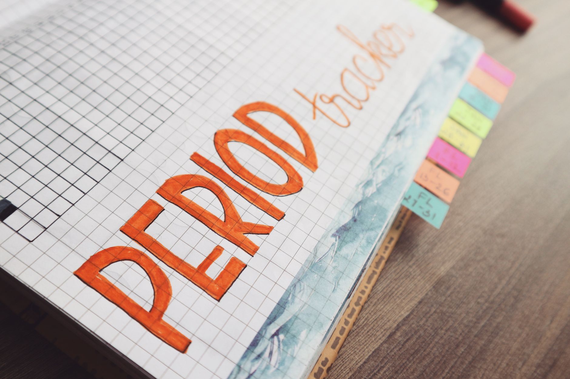 A handwritten period tracker in a journal