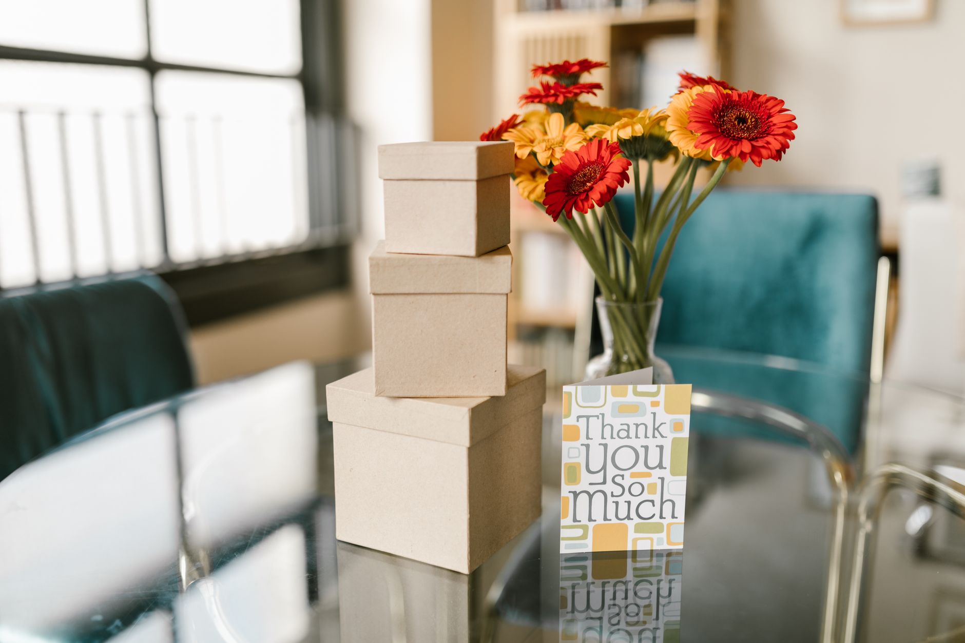 A thank-you card and flowers on a table
