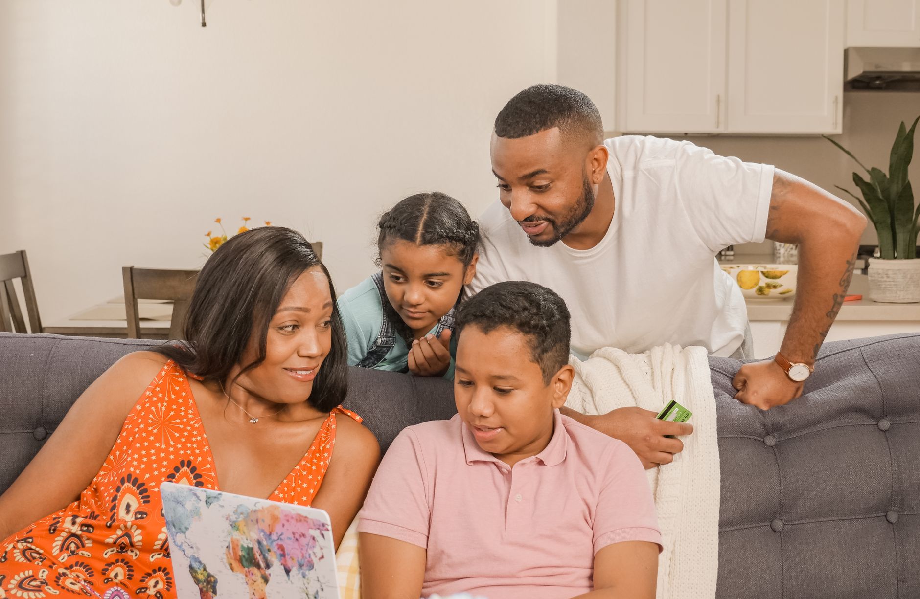 A joyful family enjoying time together in a cozy living room environment.