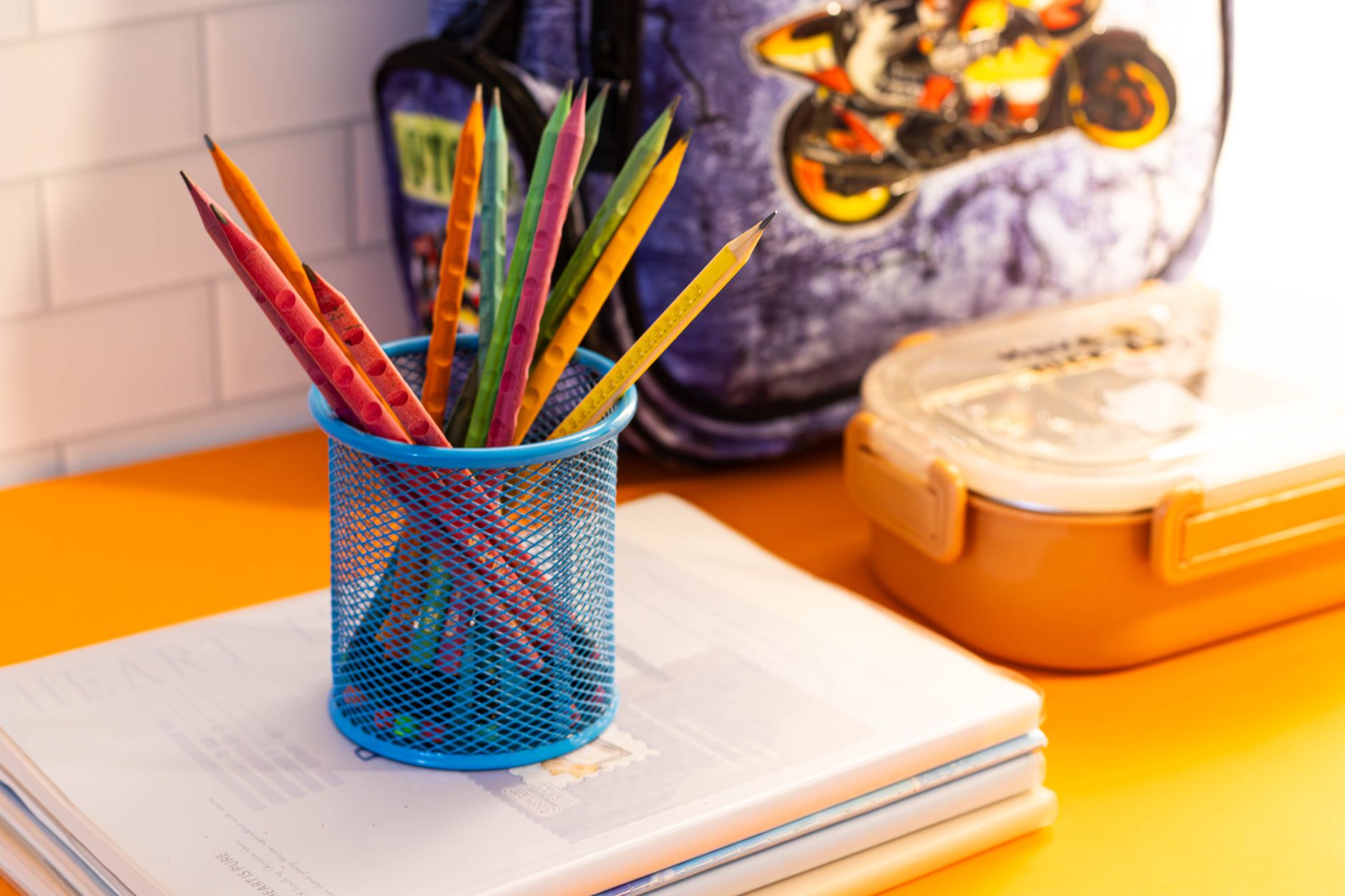 Pencils and a notebook on a desk