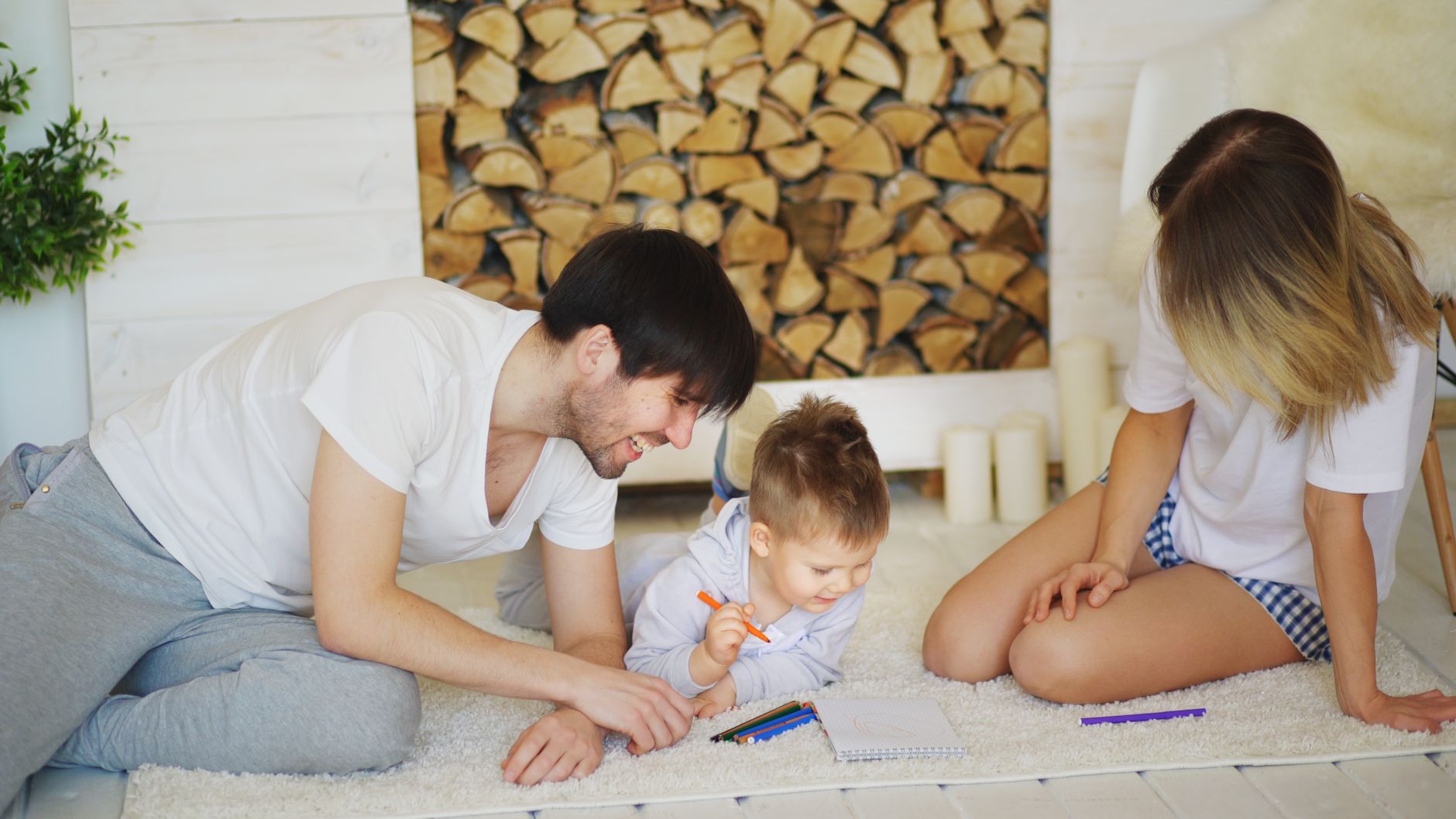 A joyful family drawing together on the living room floor, creating memories.